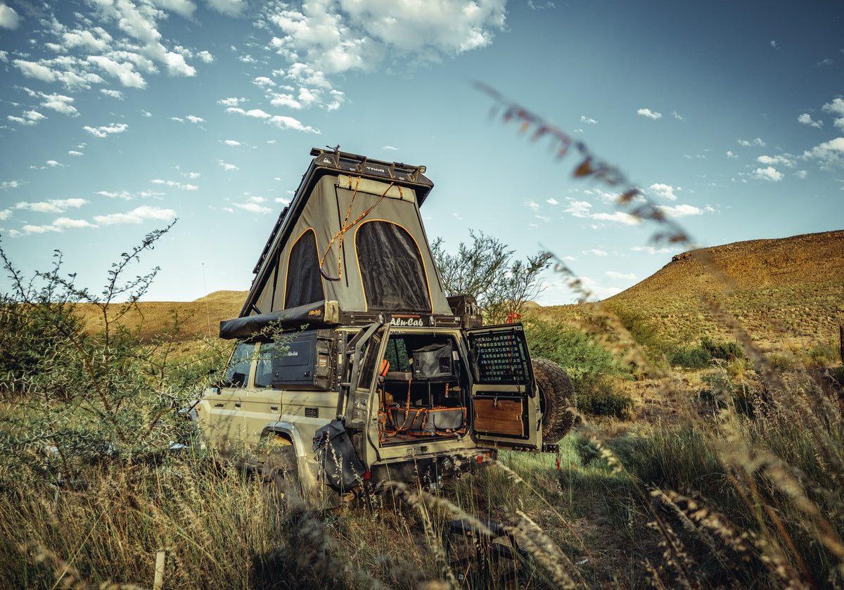 Alu-Cab Thor roof conversion on a Toyota Land Cruiser 76, tent open in the Karoo veld