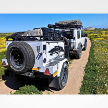 Metalian Genie off-road trailer towed by a Suzuki Jimny on a gravel road — light Code B towing, 4Matt Campers Cape Town (view 2)