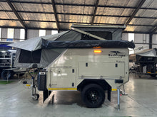 2025 Bush Lapa Miskruier side view with pop-top roof up and Bush-Wing awning stowed — pre-owned 4-sleeper off-road caravan (view 3)