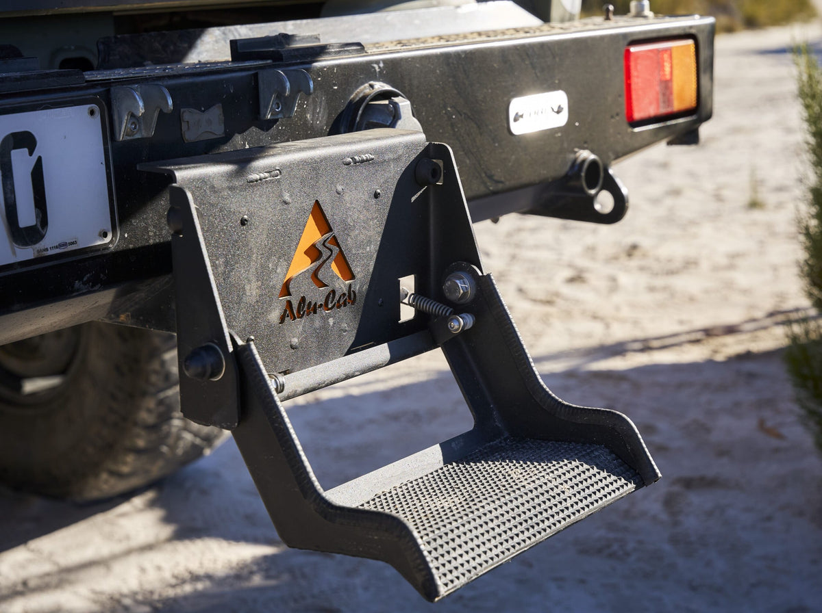 Alu-Cab Tow Bar Step folded down behind a vehicle
