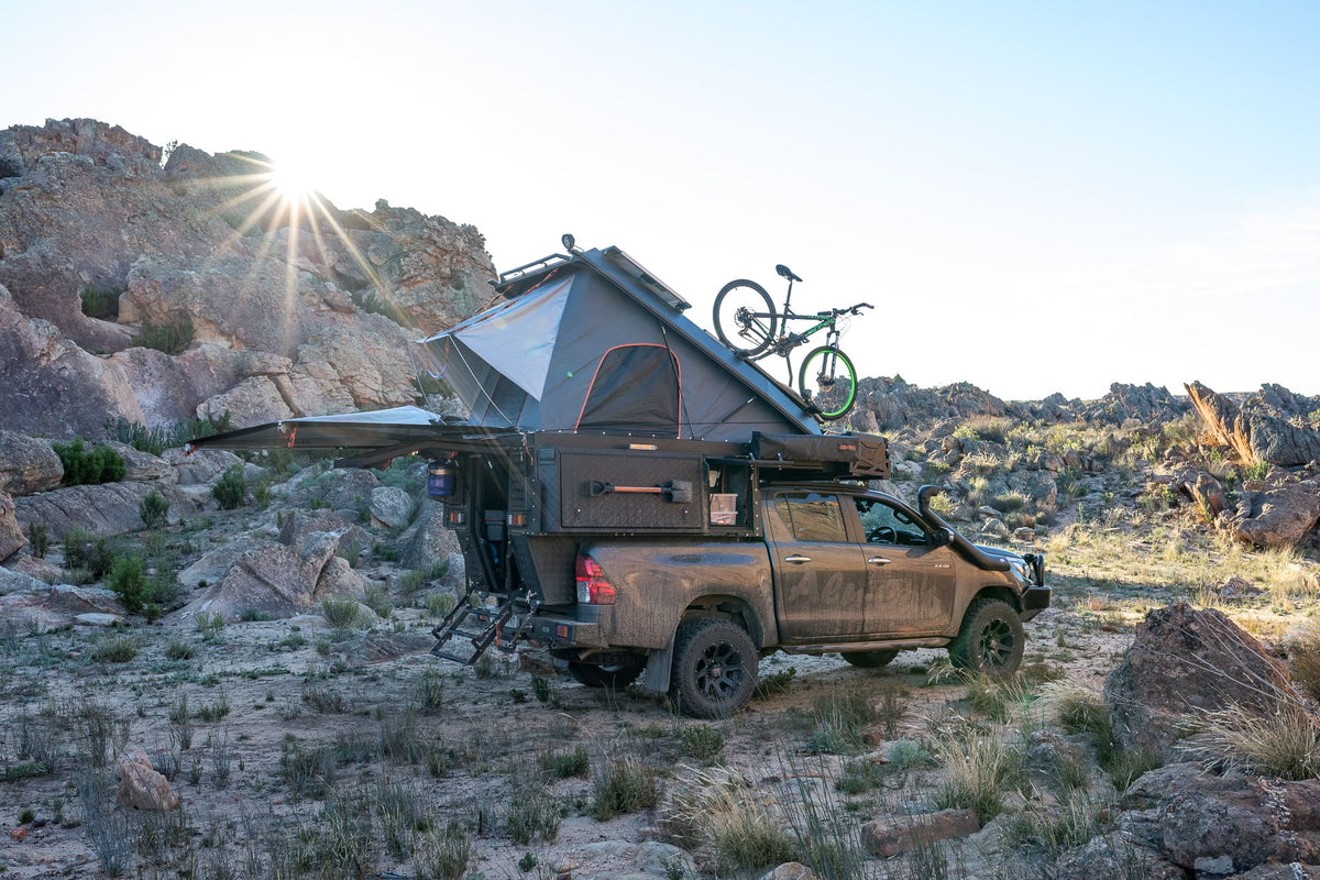 Alu-Cab Khaya Family 4 Sleeper camper unit in black on a truck