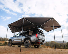 Deltawing 270° XL Awning standing with its drop-down poles deployed