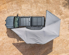 Top-down view of the Deltawing 270° XL Awning wrapping around the side and rear of a vehicle