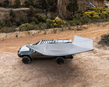 Aerial view of the Deltawing 270° XL Awning deployed on a bakkie at a bush campsite