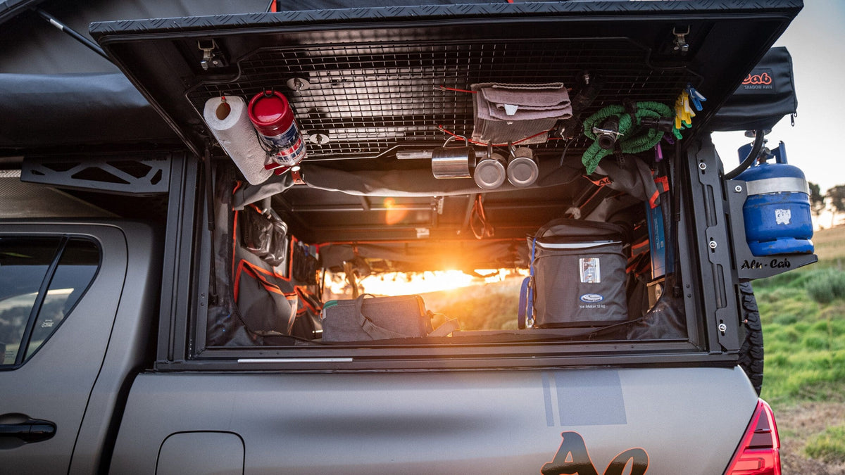 Alu-Cab Canopy Camper side door grid with gas struts