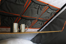 Alu-Cab Interior Roof Drop-Down Table folded down inside a camper, photo 2