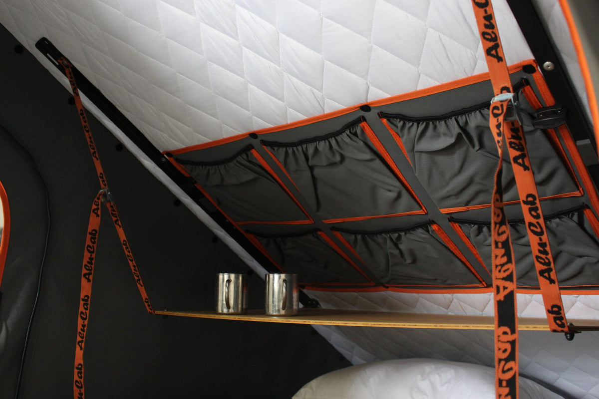Alu-Cab Interior Roof Drop-Down Table folded down inside a camper, photo 6