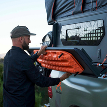 Alu-Cab Camper Trax side table folded out with recovery trax