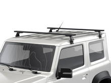 Alu-Cab Gutter Feet clamped onto a vehicle roof gutter, photo 2