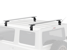 Alu-Cab Gutter Feet clamped onto a vehicle roof gutter