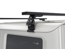 Alu-Cab Gutter Feet clamped onto a vehicle roof gutter, photo 4