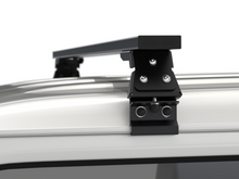 Alu-Cab Gutter Feet clamped onto a vehicle roof gutter, photo 3