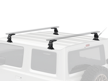 Alu-Cab Wide Gutter Feet clamped onto a vehicle gutter