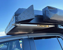 Alu-Cab Canopy Camper and Khaya table slide under the canopy overhang