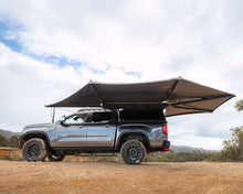 Ironman 4x4 Deltawing 270° XL Awning deployed along the side and rear of a double-cab bakkie