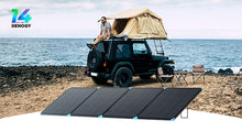 Renogy 400W Lightweight Portable Solar Panel Suitcase — deployed at a beach camp with a rooftop tent