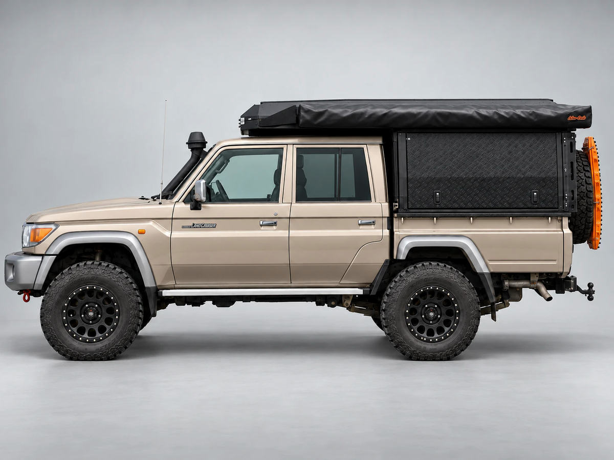Alu-Cab Canopy Camper Deluxe on a Toyota Land Cruiser 79 double cab with Shadow Awning, side view