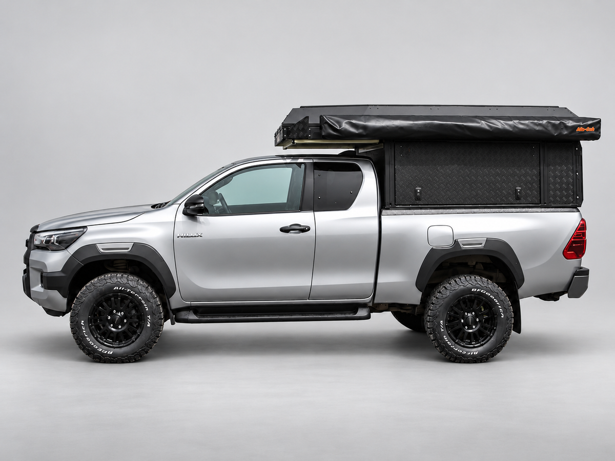 Alu-Cab Canopy Camper Deluxe on a Toyota Hilux extra cab with Shadow Awning, side view