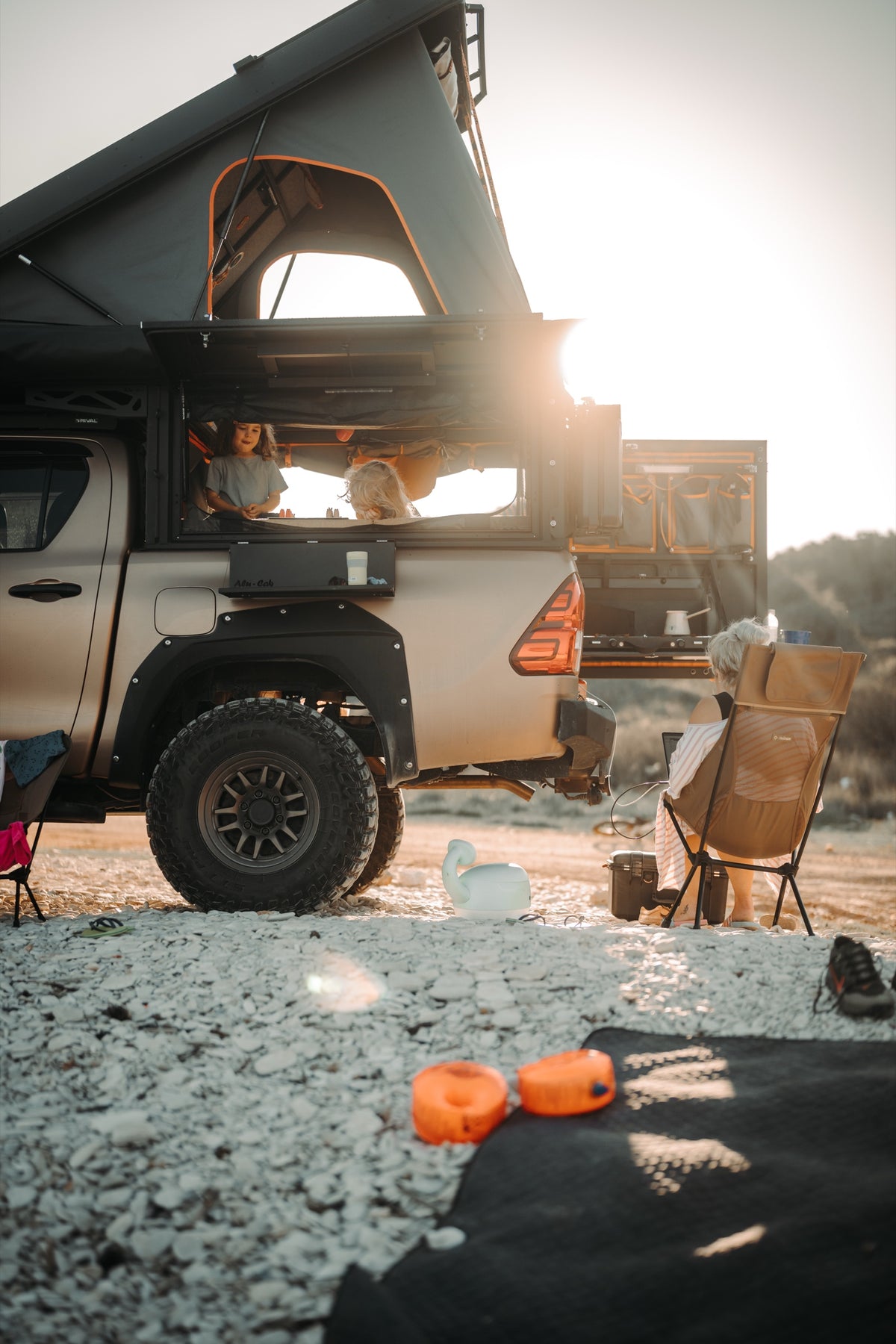 Alu-Cab Canopy Camper on a Toyota Hilux at sunset, camp set up
