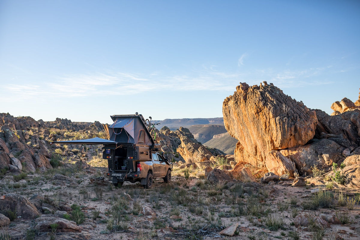 Alu-Cab Khaya camper on a Toyota Hilux with awning out among Cederberg rocks
