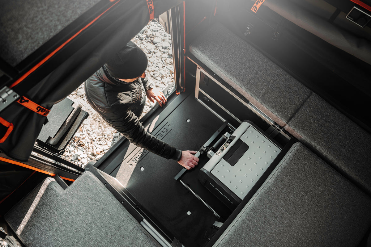 Inside an Alu-Cab ModCAP 2-sleeper camper, fridge slide and storage