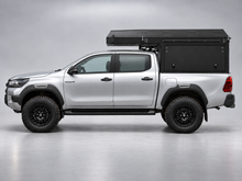 Alu-Cab ModCAP with 2-sleeper Camper Tent on a Toyota Hilux double cab, side view