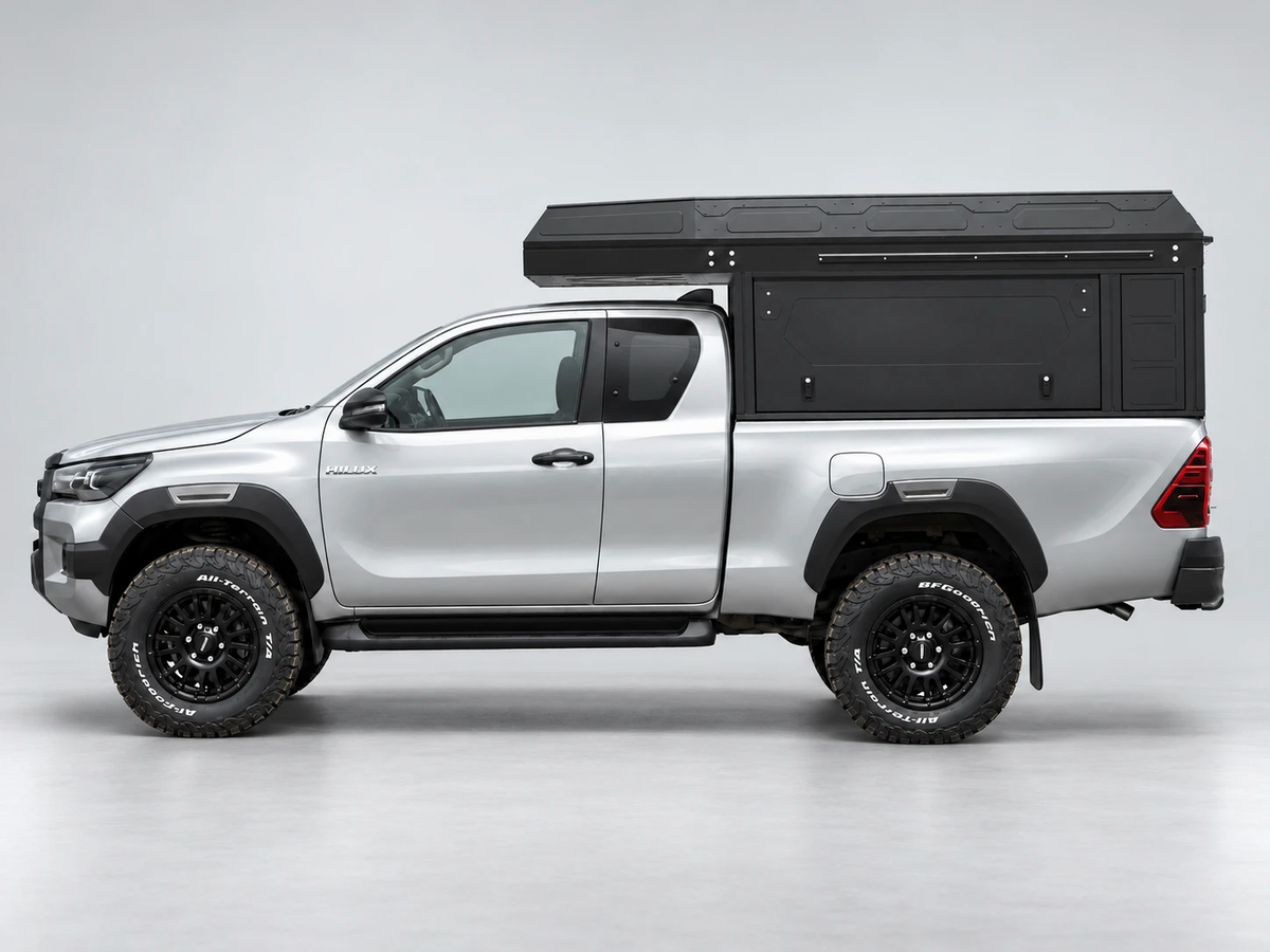 Alu-Cab ModCAP with 2-sleeper Camper Tent on a Toyota Hilux extra cab, side view