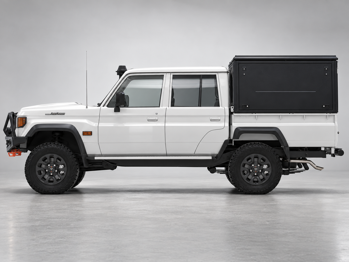 Alu-Cab ModCAP base with flat roof on a Toyota Land Cruiser 79 double cab, aluminium side windows