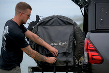 Alu-Cab Spare Wheel Bag (Large) being closed on a Hilux canopy spare wheel