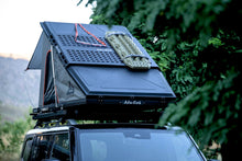 Alu-Cab LT-50 tent open with recovery boards on the Molle plate