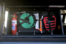 Alu-Cab molle plate in a 1250 mm canopy cupboard holding fire extinguisher, recovery strap and first aid kit