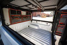 Alu-Cab water tank canvas bag kit on the tank inside a Canopy Camper