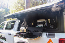 Alu-Cab Contour Canopy kitchen kit in use, kettle on stove at the fold-out table