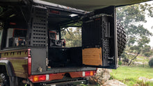Alu-Cab ModCAP rear exterior Molle plate fitted on a Land Cruiser 79 double cab, rear door kitchen open