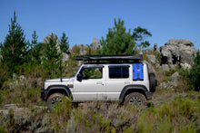 Silver Suzuki Jimny with the Alu-Cab 10L blue water jerry can on the rear quarter