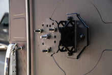 Alu-Cab spare wheel mount fitted on a camper rear door, multi-stud PCD plate