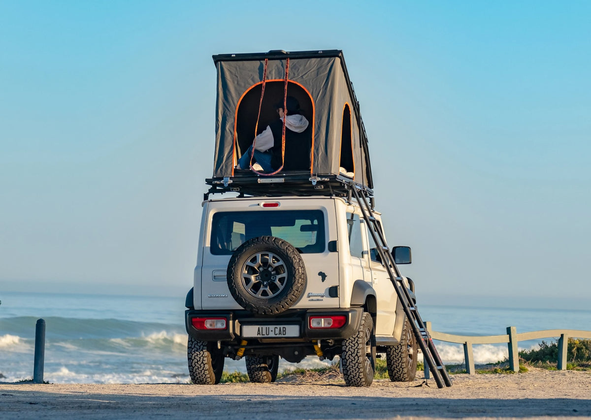Alu-Cab 2.0m telescopic ladder to an LT-50 tent on a Suzuki Jimny