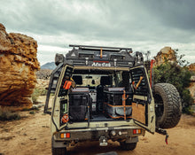 Alu-Cab rear door molle plates on a Land Cruiser 76 with the rear doors open