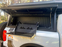 Alu-Cab 1250 mm canopy cupboard with molle plate behind the fold-out table