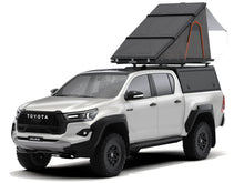 Alu-Cab LT-50 rooftop tent open on a Toyota Hilux, product render