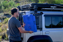 Alu-Cab Jimny 10L blue water jerry can being fitted to a Jimny