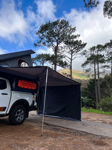 Alu-Cab Universal Side Panel on a Shadow Awning beside a Hilux