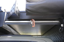Alu-Cab table slide fitted under the Khaya canopy overhang, latch and strap closed