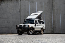 Alu-Cab Hercules white roof conversion open on a white Land Cruiser 78 Troopy