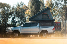 Toyota Hilux with Alu-Cab Canopy Camper, side view with tent open
