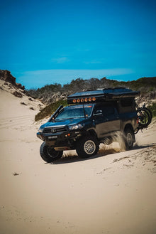 Toyota Hilux ModCAP with 4-sleeper Family Camper Tent in the dunes