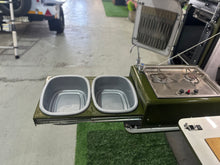 Slide-out kitchen with two basins, tap and 2-plate gas stove