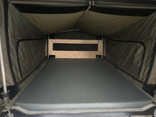 Queen-size bed inside the pneumatic pop-top