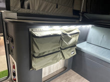 Canvas storage pockets and fire extinguisher inside the camper