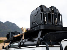 Two jerry cans secured on a roof rack